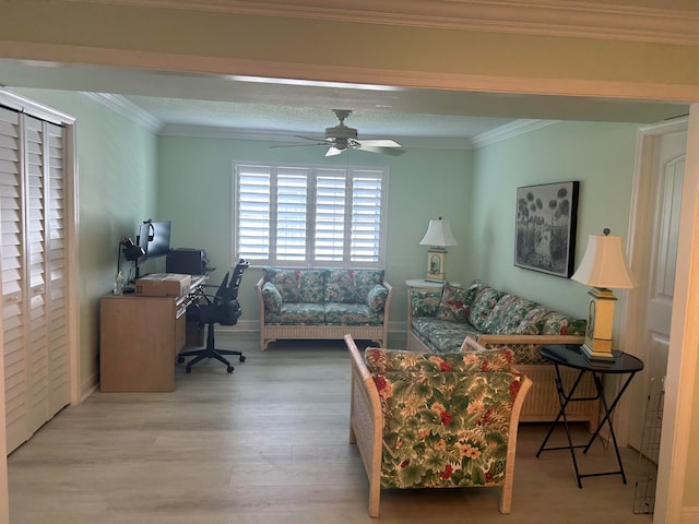 living room with wood-type flooring, ceiling fan, and ornamental molding