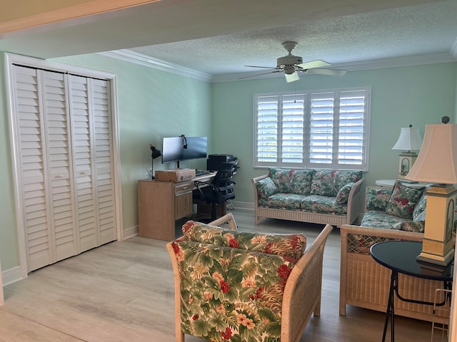 living room with crown molding, a textured ceiling, light hardwood / wood-style flooring, and ceiling fan