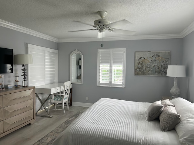 bedroom featuring ceiling fan, crown molding, light hardwood / wood-style floors, and a textured ceiling