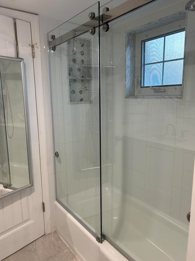 bathroom featuring tile patterned floors and combined bath / shower with glass door