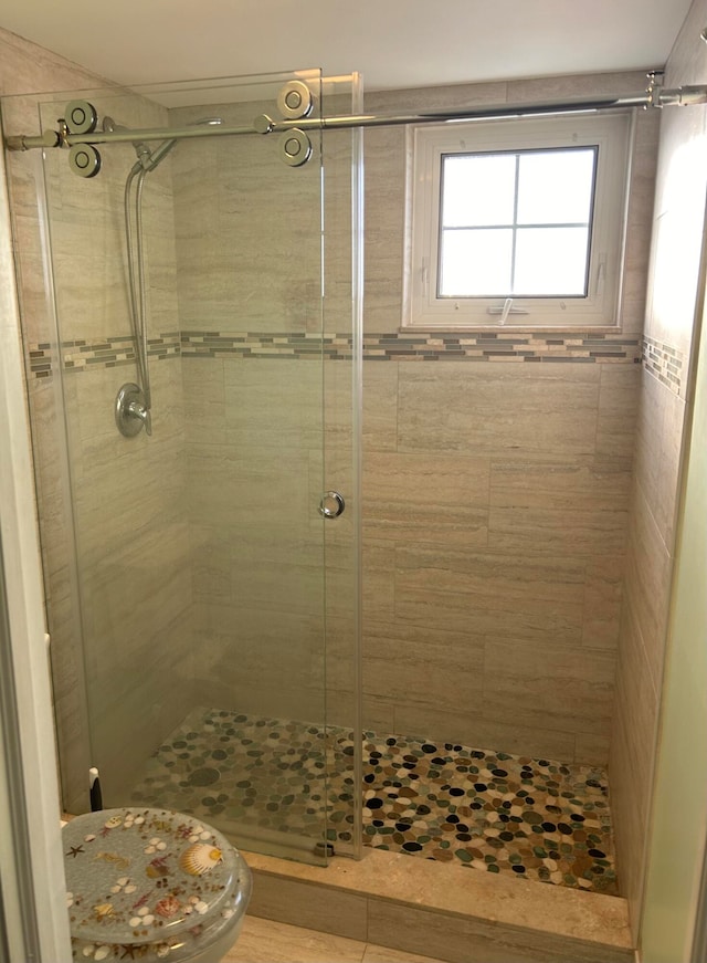 bathroom with an enclosed shower and toilet