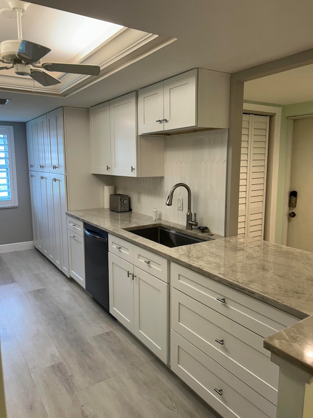 kitchen featuring sink, white cabinets, dishwasher, and light hardwood / wood-style floors