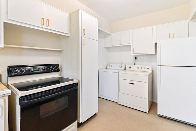 kitchen featuring washer and clothes dryer, white appliances, white cabinetry, and light colored carpet