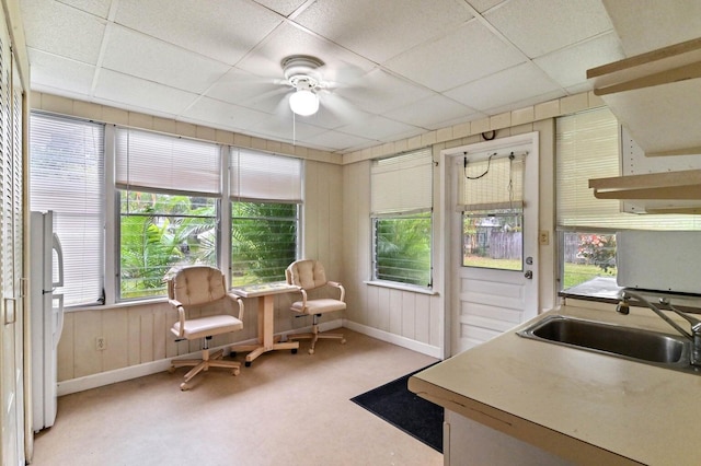 sunroom / solarium with a paneled ceiling, sink, and plenty of natural light