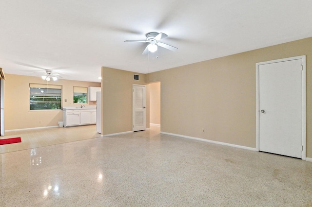 interior space with ceiling fan and sink