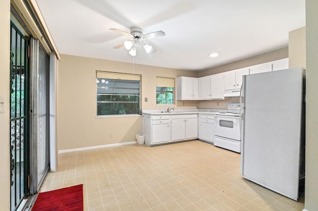 kitchen with white appliances, white cabinetry, sink, and ceiling fan