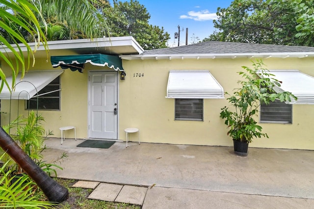 view of exterior entry featuring a patio