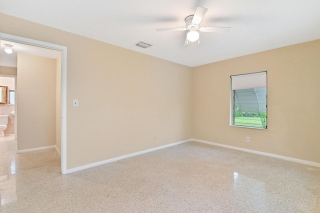 empty room with ceiling fan and a wealth of natural light