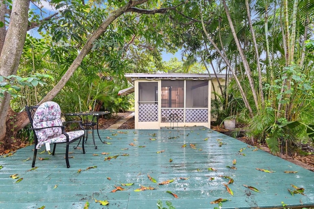 wooden deck featuring a sunroom