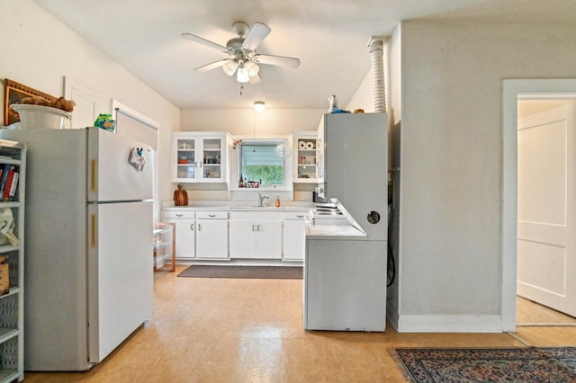 kitchen with white cabinets, sink, ceiling fan, and white fridge