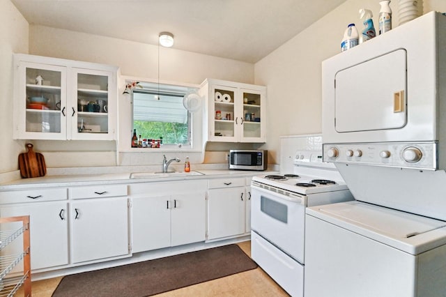 kitchen featuring stacked washer and clothes dryer, white electric range, sink, and white cabinetry