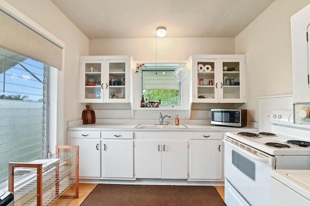 kitchen with white cabinetry, white range with electric stovetop, and sink