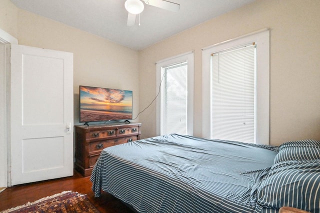 bedroom with ceiling fan and dark hardwood / wood-style flooring