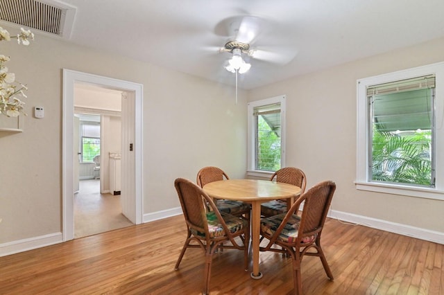 dining area with ceiling fan, hardwood / wood-style flooring, and a healthy amount of sunlight