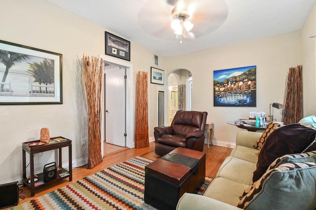 living room with light wood-type flooring and ceiling fan