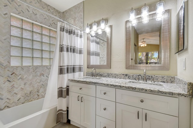 bathroom with double vanity, shower / tub combo, ceiling fan, and a sink