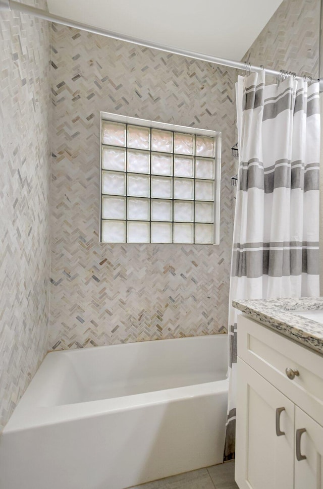 bathroom featuring tile patterned flooring, shower / tub combo with curtain, and vanity