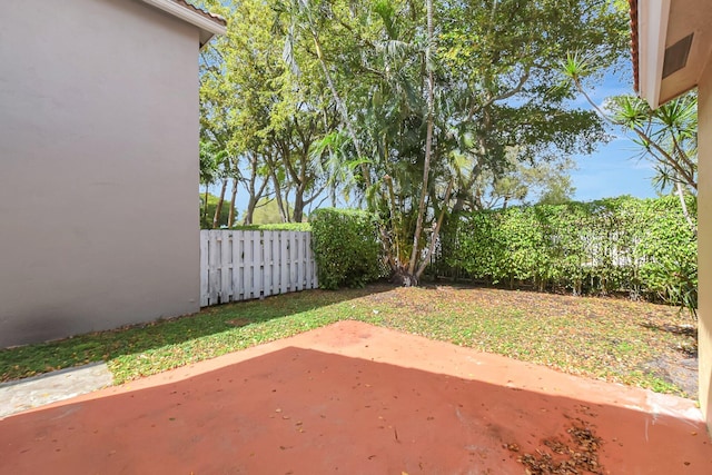 view of yard with fence and a patio