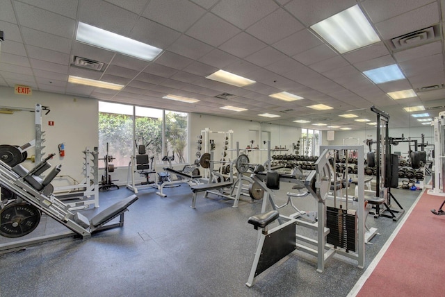 exercise room with a drop ceiling and visible vents