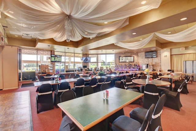 dining space featuring recessed lighting, visible vents, and a tray ceiling