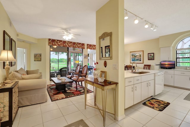 kitchen featuring ceiling fan, dishwasher, white cabinets, and sink