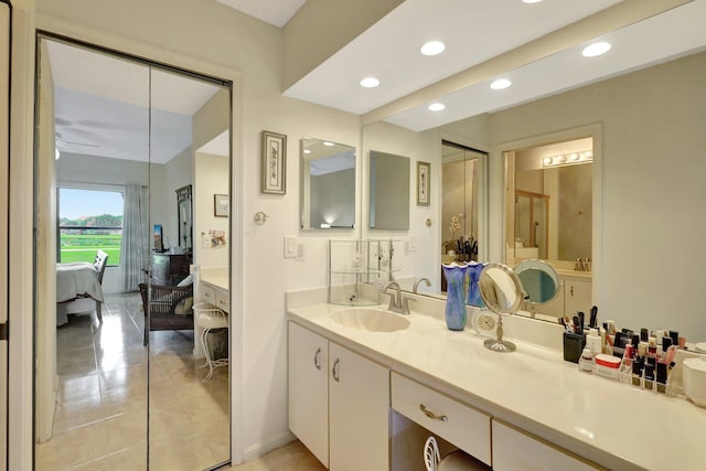 bathroom featuring tile patterned floors, ceiling fan, and vanity