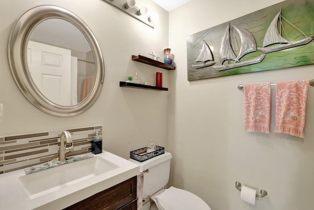 bathroom featuring vanity, backsplash, and toilet