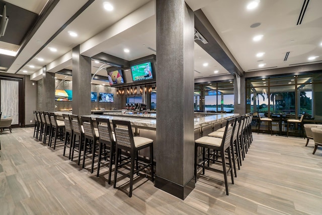 bar with light wood-type flooring