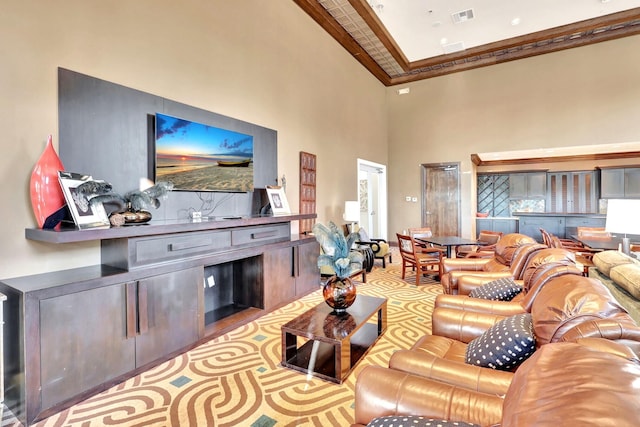 living room featuring ornamental molding and high vaulted ceiling