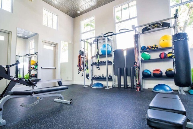 workout area featuring a high ceiling