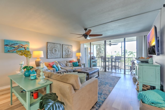 living room featuring ceiling fan, a textured ceiling, and hardwood / wood-style floors