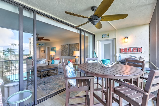 dining room featuring ceiling fan and a textured ceiling