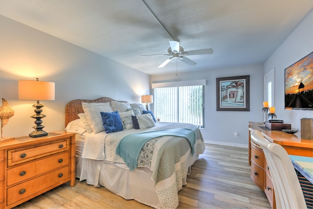 bedroom featuring light hardwood / wood-style floors and ceiling fan