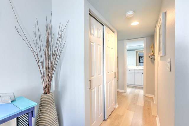 corridor with light hardwood / wood-style floors