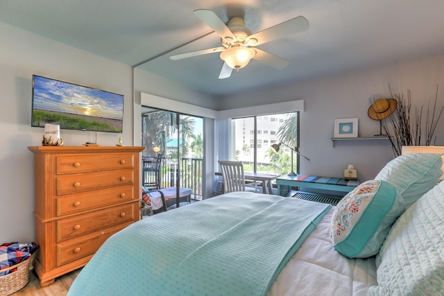 bedroom with wood-type flooring, access to exterior, and ceiling fan