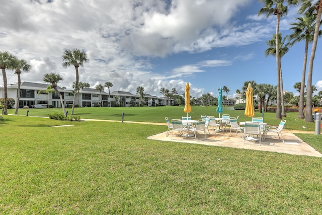 view of home's community with a patio and a yard