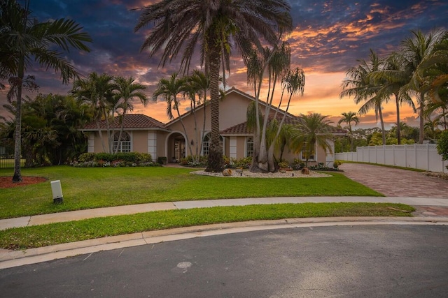 mediterranean / spanish-style home featuring a lawn