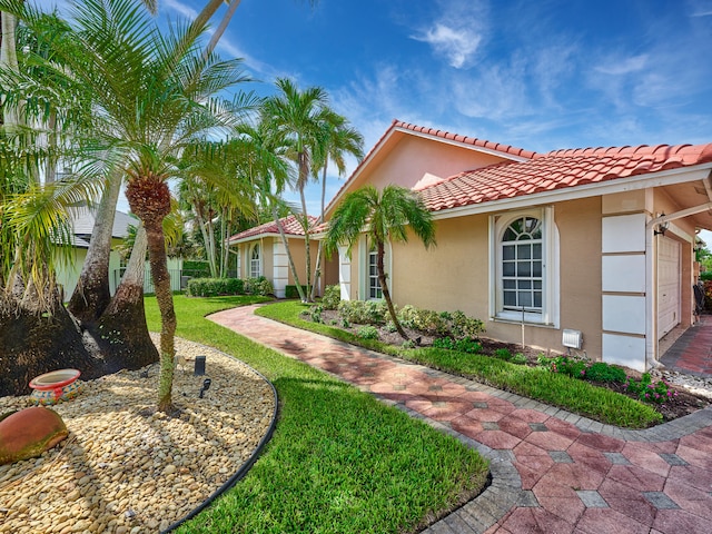 view of front of house with a front yard and a garage