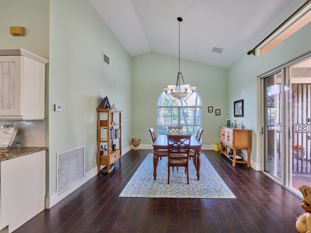 dining space featuring an inviting chandelier, dark hardwood / wood-style floors, and high vaulted ceiling