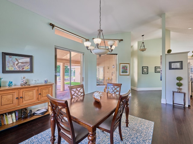 dining room with lofted ceiling, a chandelier, and dark wood-type flooring