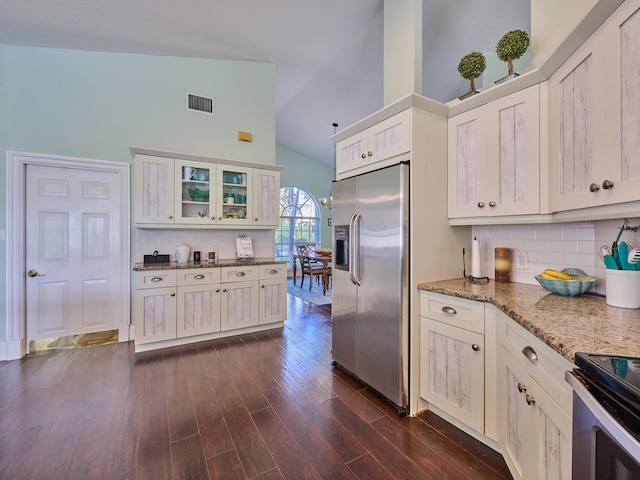 kitchen featuring high vaulted ceiling, stainless steel appliances, white cabinetry, and dark wood-type flooring