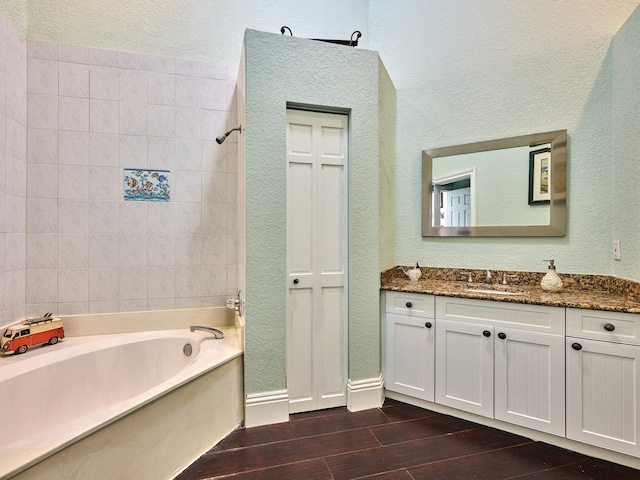 bathroom featuring wood-type flooring, vanity, and shower with separate bathtub