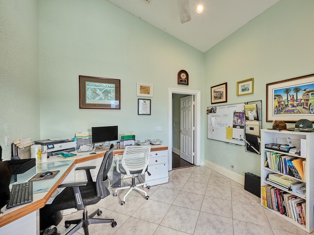 home office with light tile patterned flooring and high vaulted ceiling