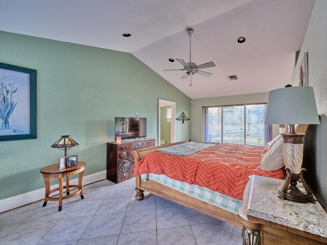 tiled bedroom with lofted ceiling and ceiling fan