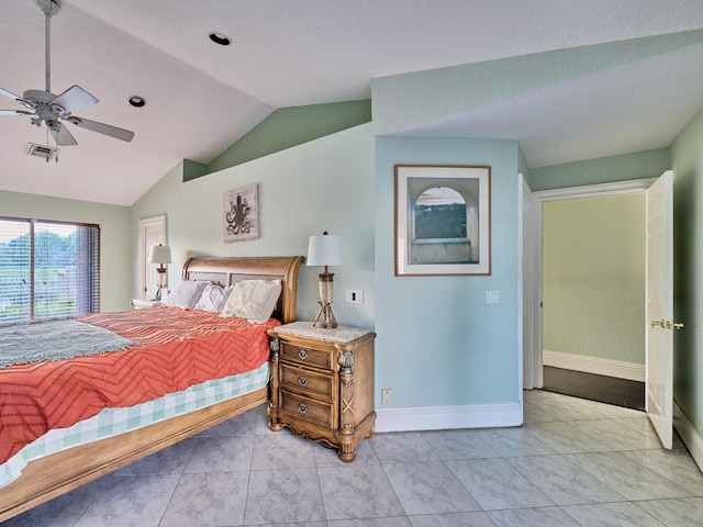 bedroom with lofted ceiling, ceiling fan, light tile patterned flooring, and a textured ceiling