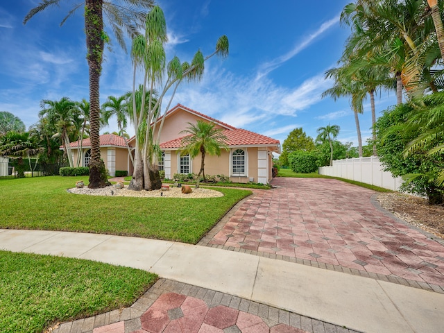 mediterranean / spanish-style house featuring a front yard