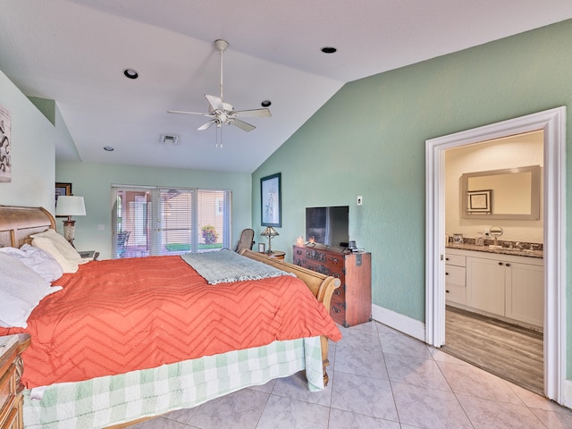 bedroom featuring ceiling fan, ensuite bathroom, light wood-type flooring, and vaulted ceiling