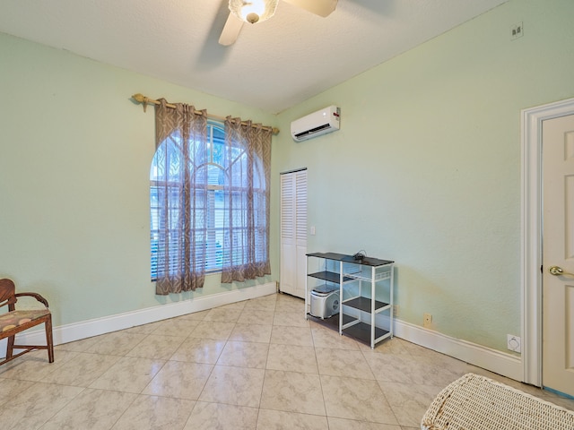 unfurnished room featuring a textured ceiling, light tile patterned flooring, ceiling fan, and a wall mounted air conditioner