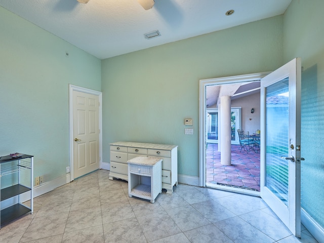 interior space with ceiling fan and a textured ceiling