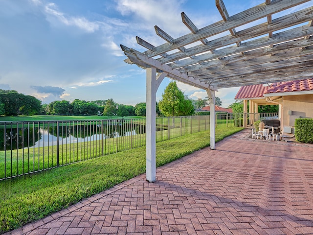 view of patio / terrace with a water view and a pergola